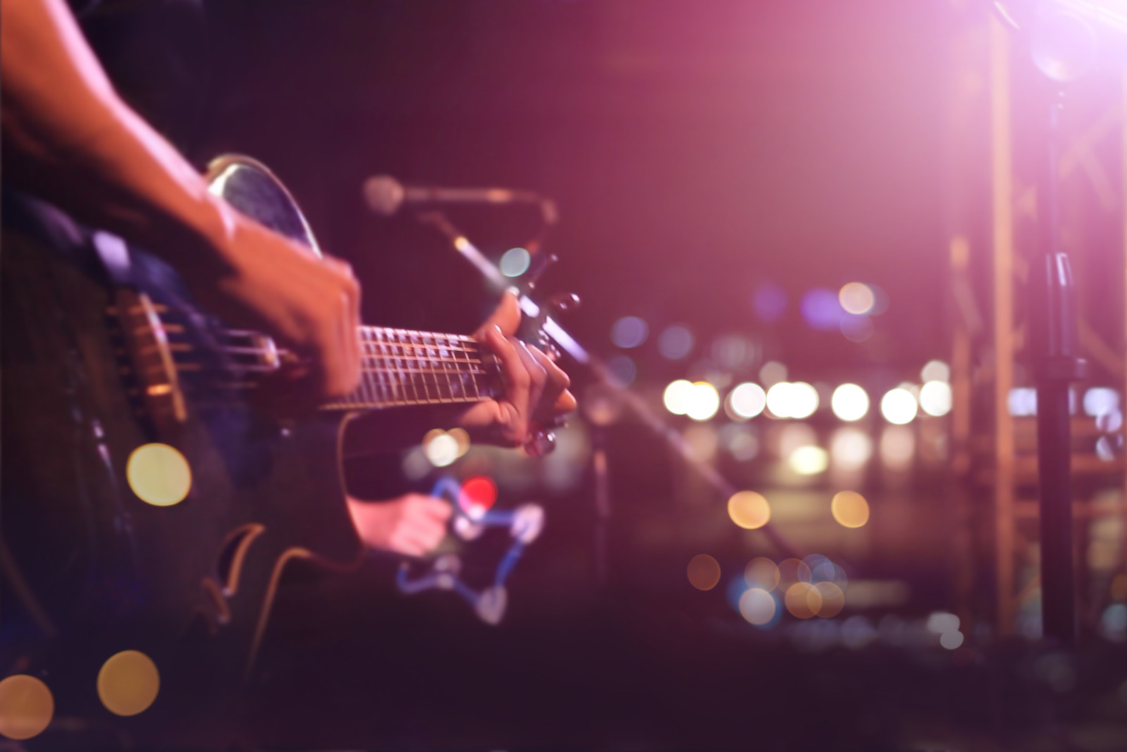 Guitarist on stage for background, soft and blur concept Guitarist on stage for background, soft and blur concept